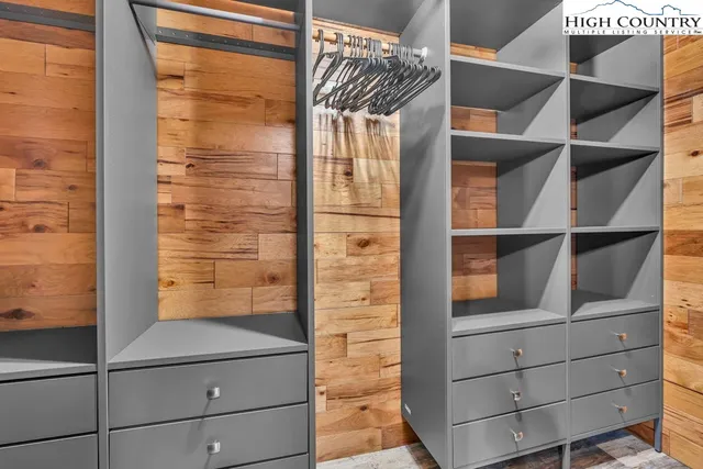 a living room with patio furniture and a chandelier