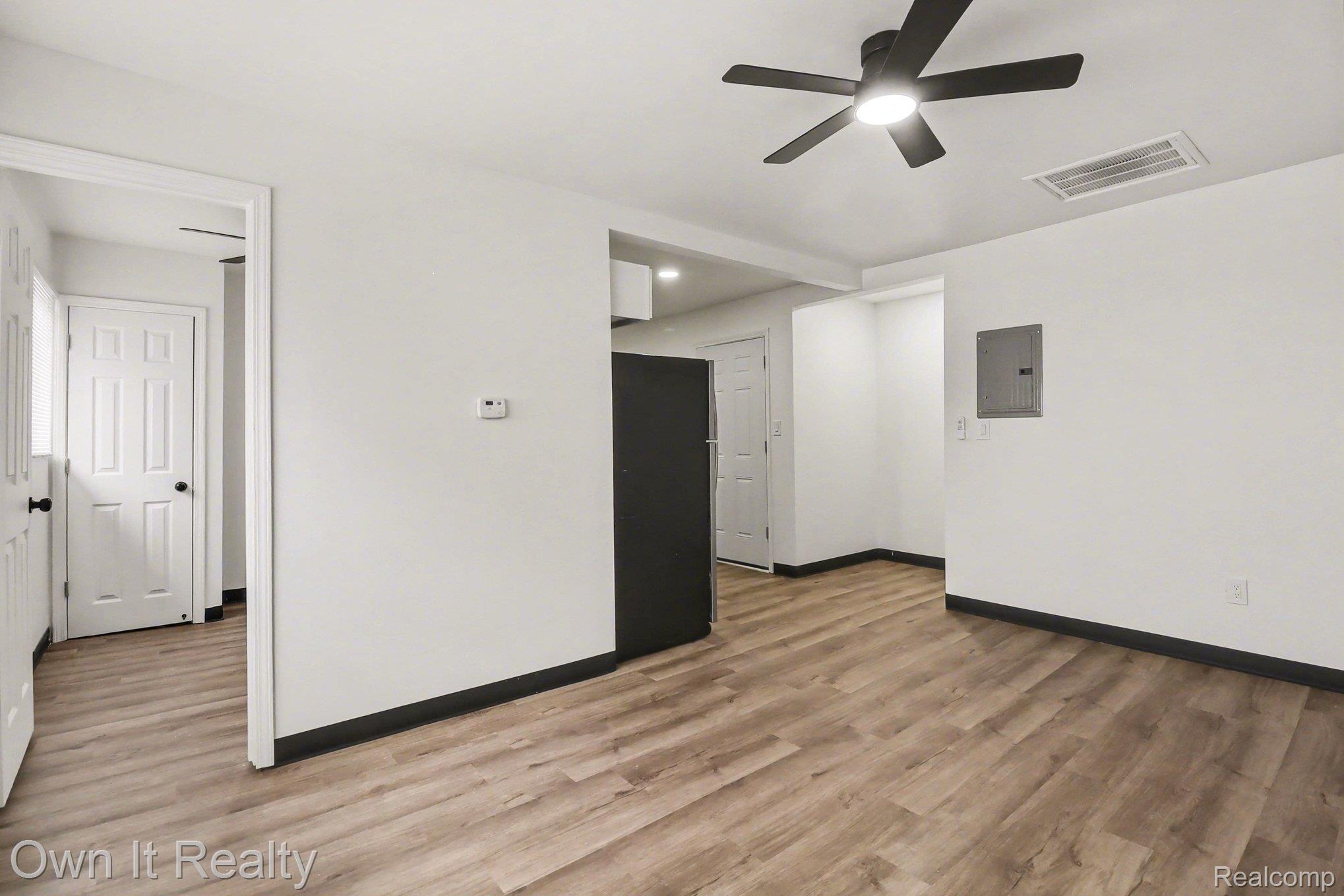 3 Joy Road, Unit 3 Detroit, MI 48228 - Photo 9 of 37 Unfurnished room featuring a ceiling fan, electric panel, and light wood-style floors