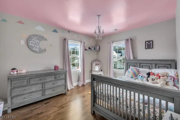 a bedroom with furniture and a large window