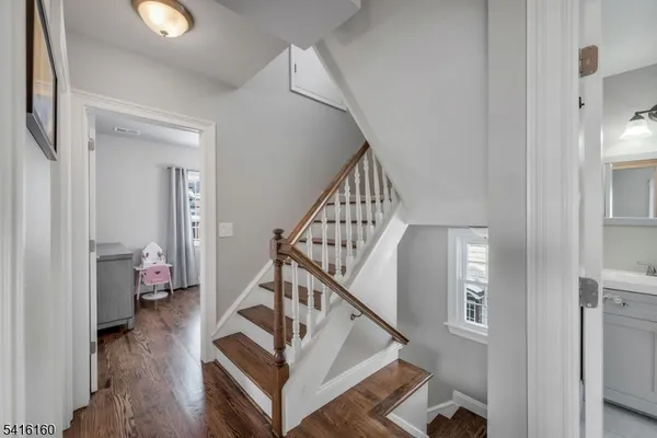 a view of entryway and hall with wooden floor