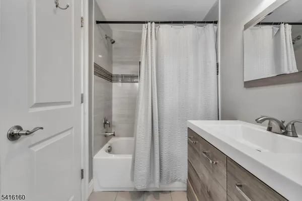 a bathroom with a sink a mirror and a shower