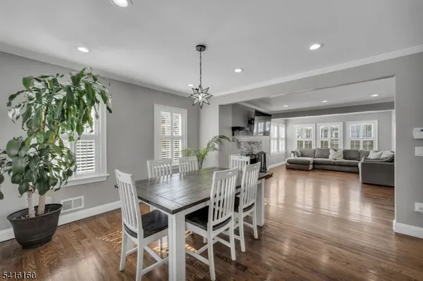 a dining room with furniture and wooden floor
