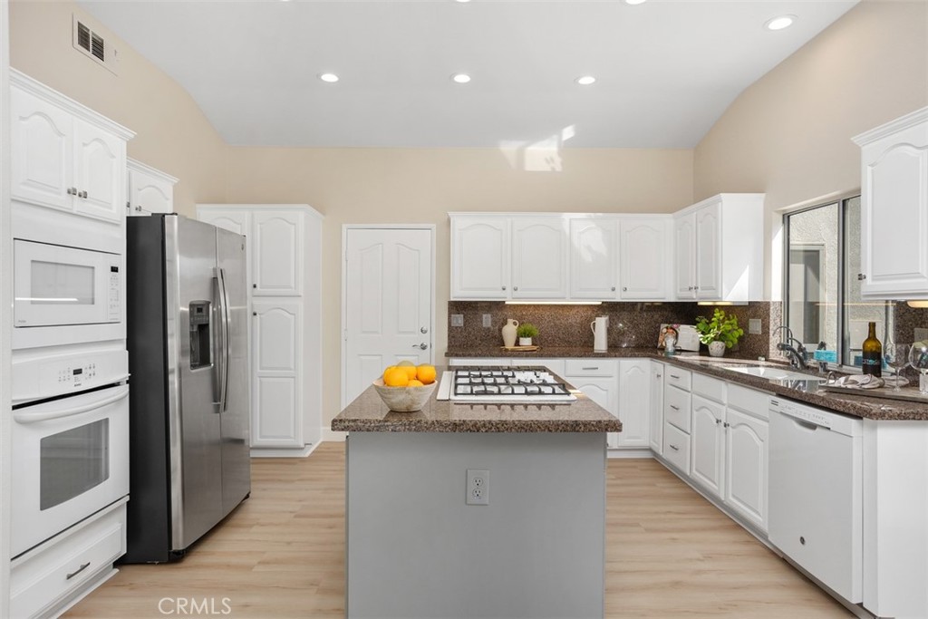 1795 Palomares Road Fallbrook, CA 92028 - Photo 12 of 37 a kitchen with stainless steel appliances a refrigerator sink and cabinets