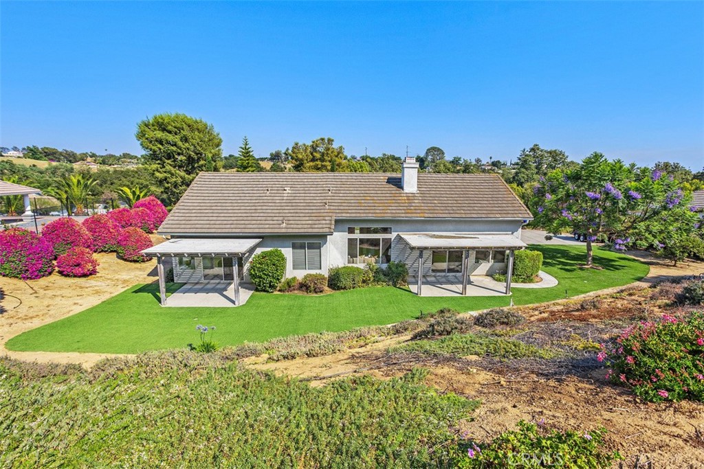1795 Palomares Road Fallbrook, CA 92028 - Photo 2 of 37 a front view of a house with a yard and garage