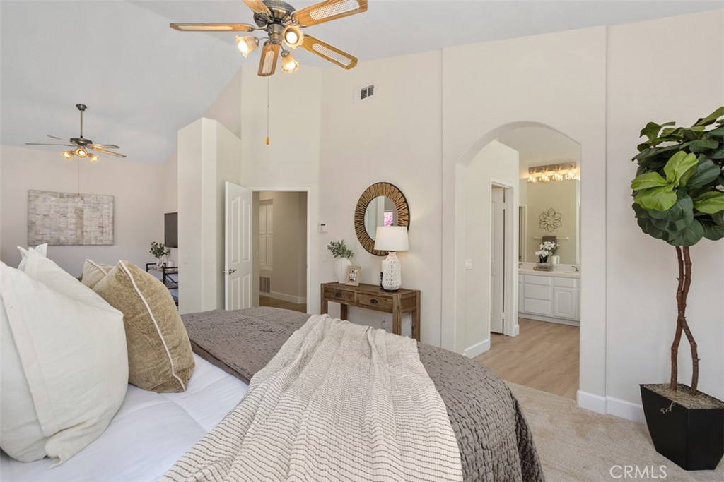 1795 Palomares Road Fallbrook, CA 92028 - Photo 21 of 37 a bedroom with a bed and a chandelier