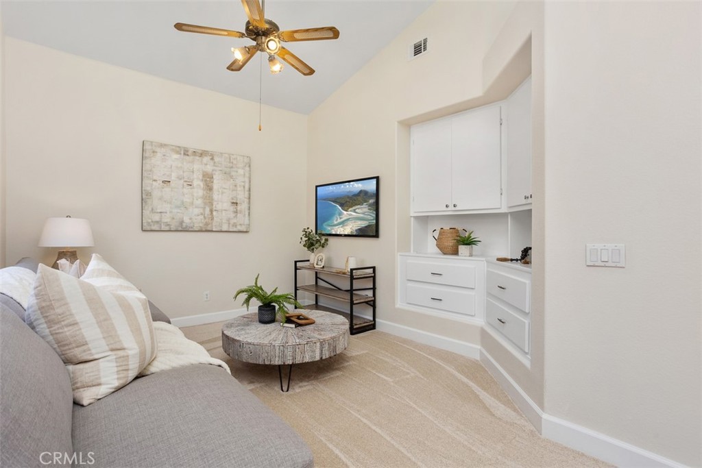 1795 Palomares Road Fallbrook, CA 92028 - Photo 23 of 37 a spacious bedroom with a bed and a chandelier