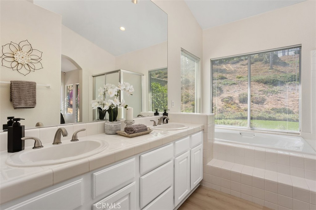 1795 Palomares Road Fallbrook, CA 92028 - Photo 24 of 37 a bathroom with a double vanity sink and a large mirror