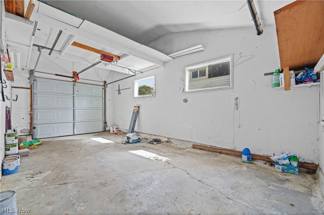 150 Graham Road Cuyahoga Falls, OH 44223 - Photo 25 of 38 Spacious garage featuring a concrete floor, white panel garage door, and two windows providing natural light