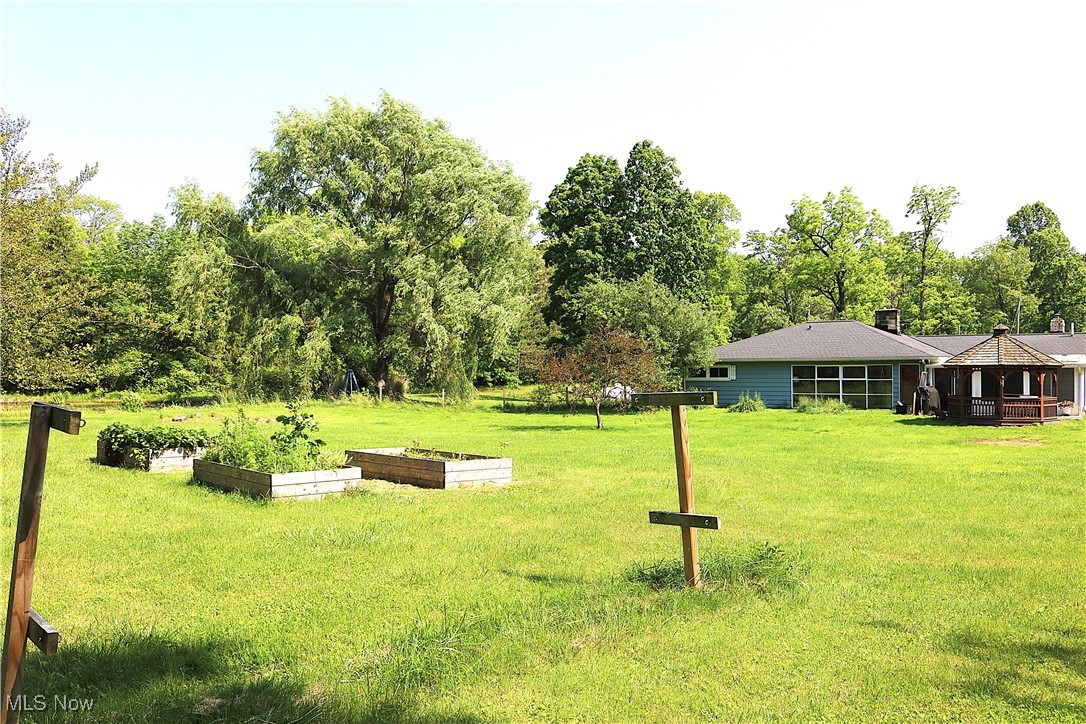 14485 Bass Lake Road Newbury, OH 44065 - Photo 7 of 22 View of grassy yard with a vegetable garden