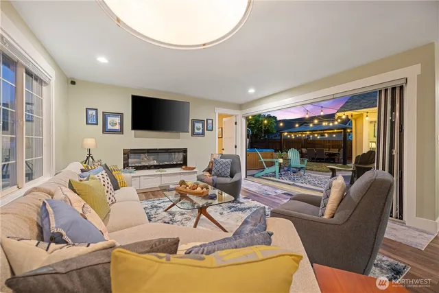 a living room with furniture a flat screen tv and a fireplace