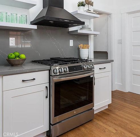a stove top oven sitting inside of a kitchen
