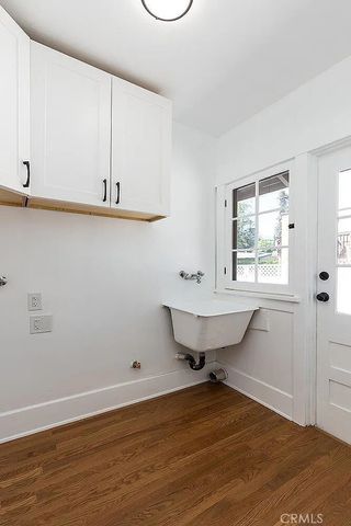 a view of a room with wooden floor and fan