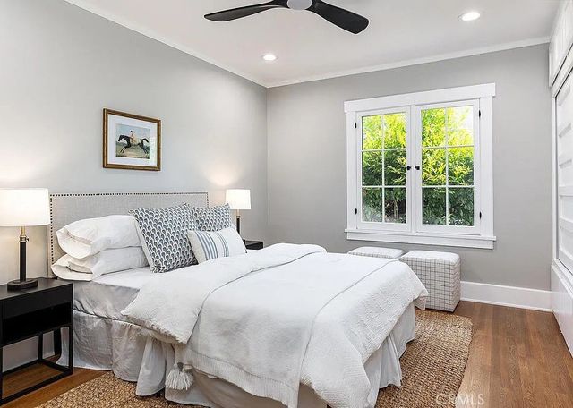 a bedroom with a bed and a large window