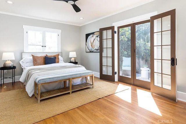 a bedroom with a large bed and a large window with outer view