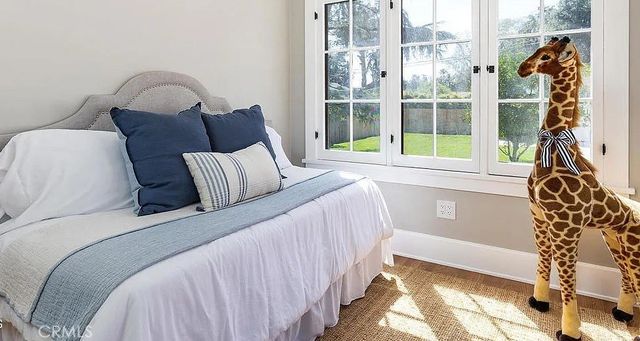 a bed sitting in a bedroom next to a window