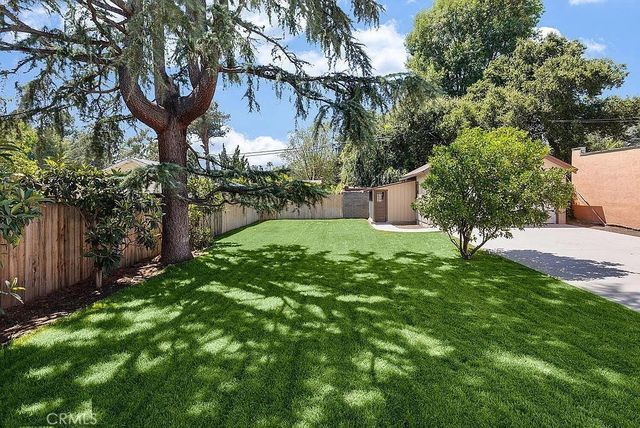 a view of a backyard with large trees
