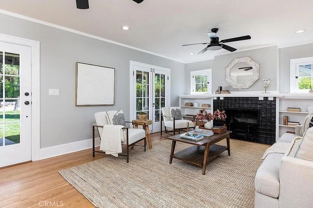 a living room with furniture a fireplace and a large window