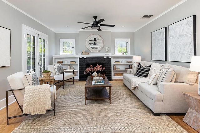 a living room with furniture a fireplace and a window