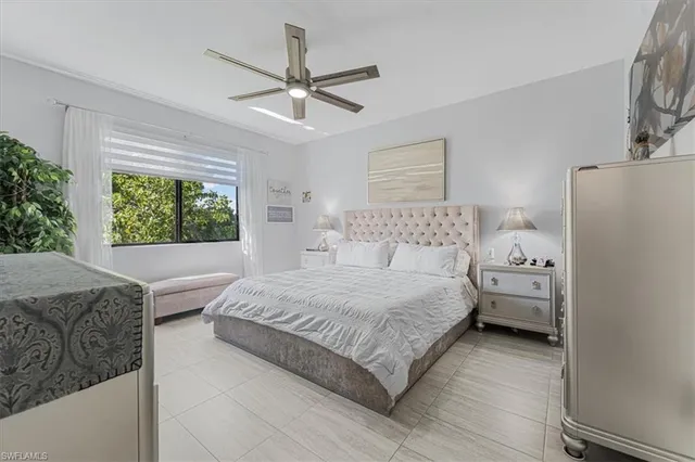 a bedroom with a large bed and a window