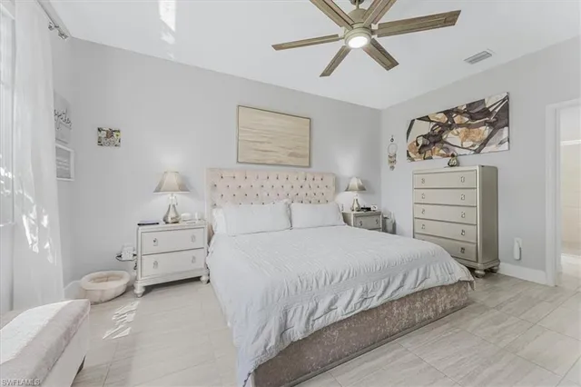 a bedroom with a bed and ceiling fan