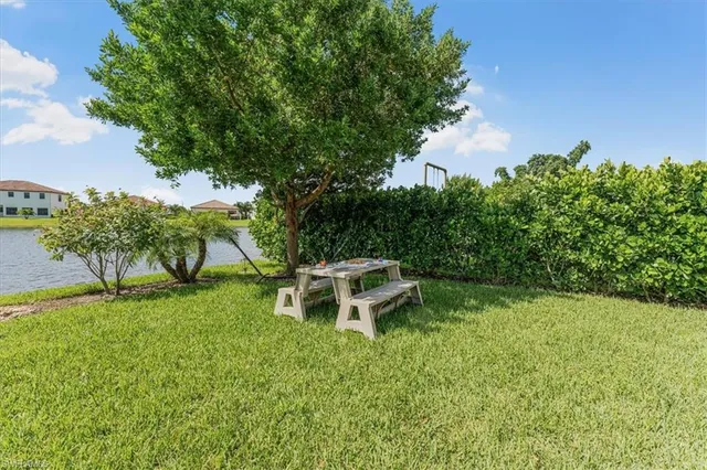 a view of a backyard with wooden fence