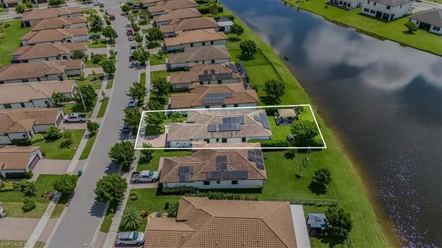 an aerial view of a house with a yard
