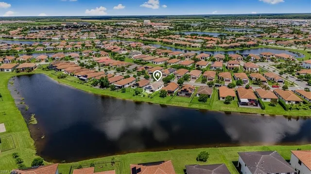 an aerial view of a houses with a yard