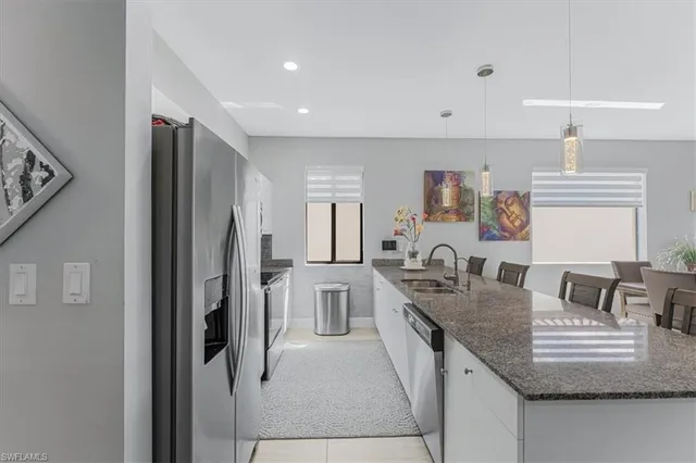 a kitchen with stainless steel appliances granite countertop a refrigerator and a sink