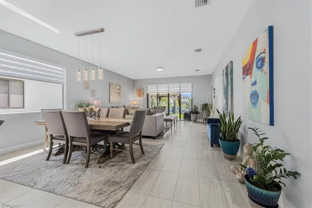 a living room with furniture flowerpot and wooden floor