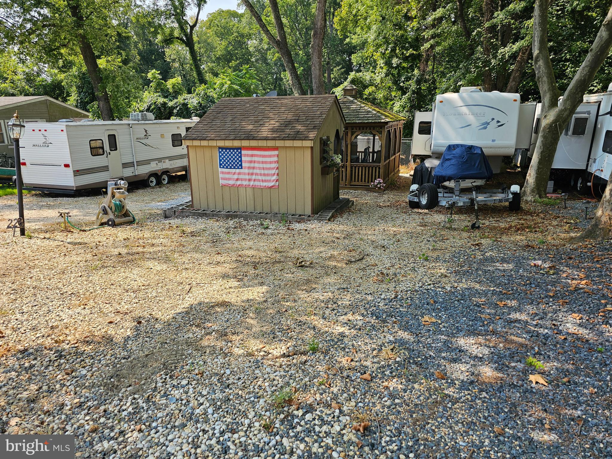 227-226 Little Beaver Lane, Unit GLEN 1 Earleville, MD 21919 - Photo 1 of 26 a backyard of a house with fire pit and outdoor seating