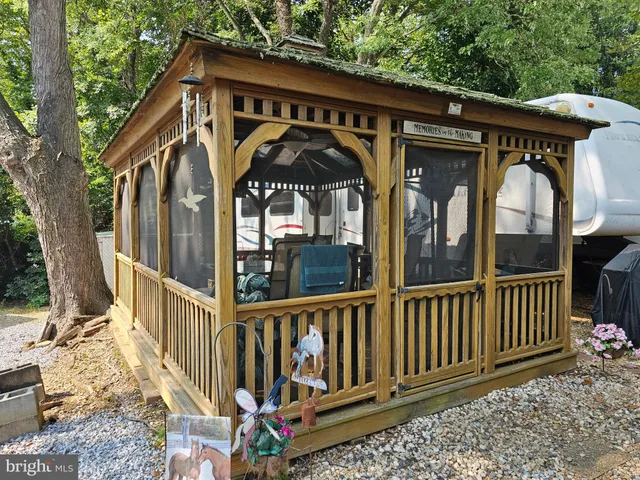 a view of a wooden house with a small yard