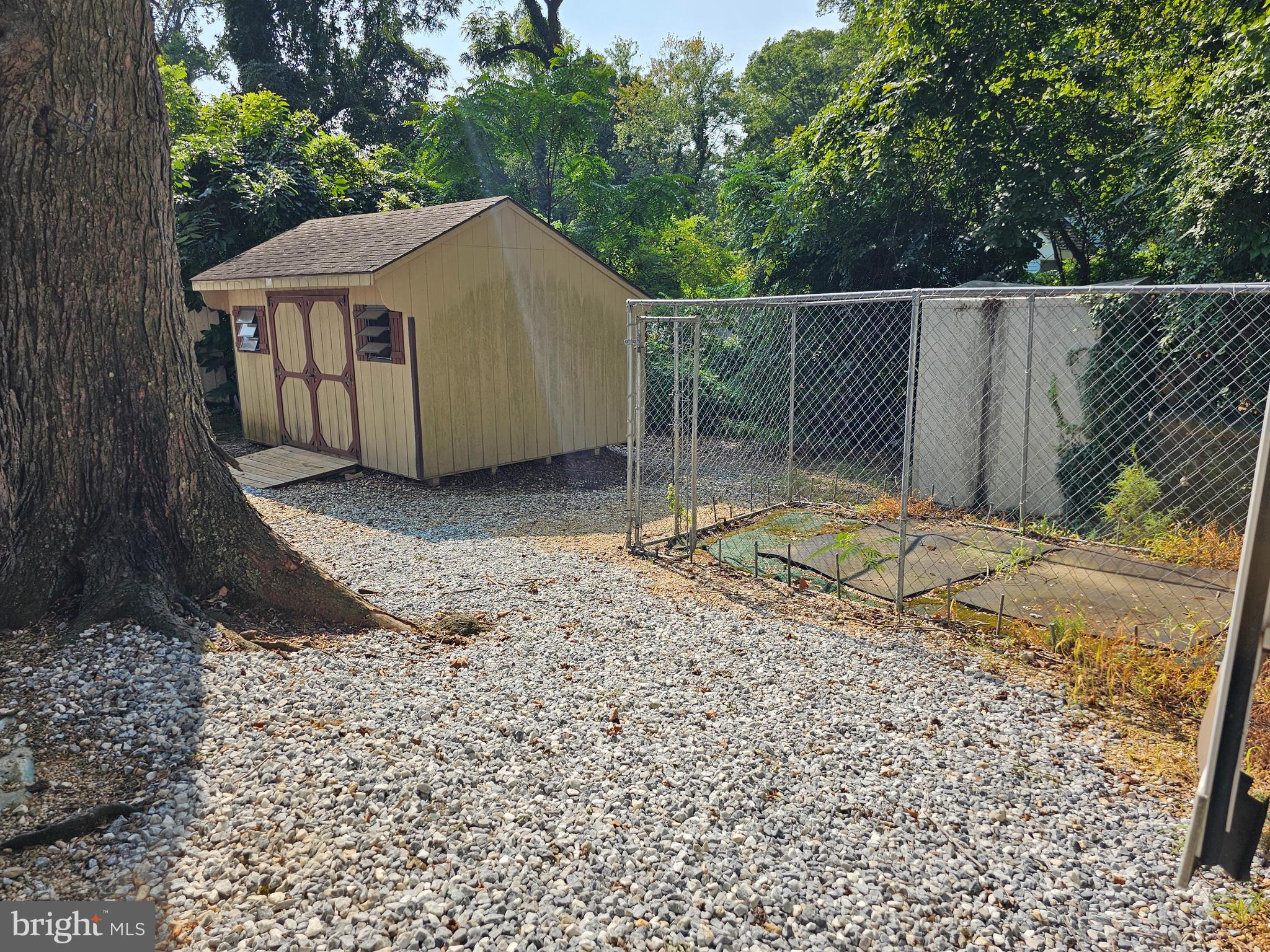 227-226 Little Beaver Lane, Unit GLEN 1 Earleville, MD 21919 - Photo 23 of 26 a backyard of a house with a yard and garage