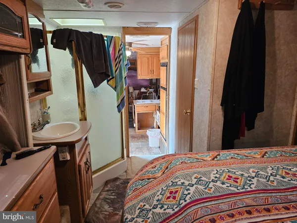 a bedroom with a bed and a mirror on the dresser