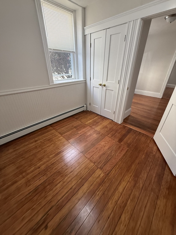 39 Newhall Street, Unit 20 Lynn, MA 01902 - Photo 3 of 11 a view of an empty room with wooden floor and a window