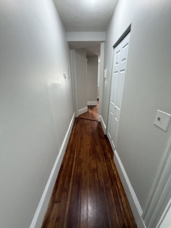 39 Newhall Street, Unit 20 Lynn, MA 01902 - Photo 9 of 11 a view of a hallway with wooden floor