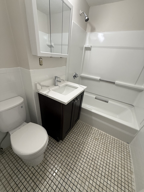 39 Newhall Street, Unit 20 Lynn, MA 01902 - Photo 10 of 11 a bathroom with a sink toilet and vanity