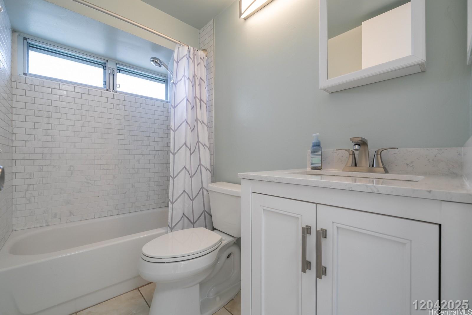 2525 Date Street, Unit 2405 Honolulu, HI 96826 - Photo 11 of 14 a bathroom with a sink a toilet and shower