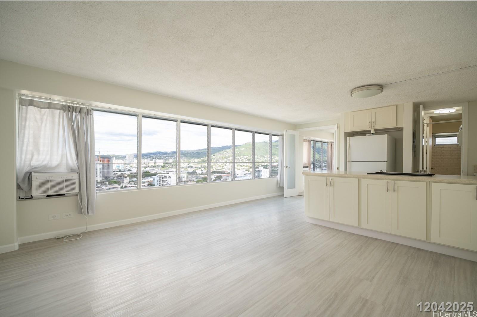 2525 Date Street, Unit 2405 Honolulu, HI 96826 - Photo 2 of 14 a view of a kitchen with a sink and dishwasher with wooden floor