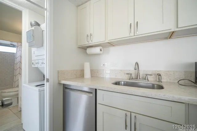 a kitchen with white cabinets and a sink