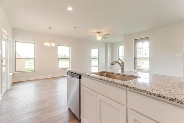 a kitchen with granite countertop white cabinets and a granite counter tops