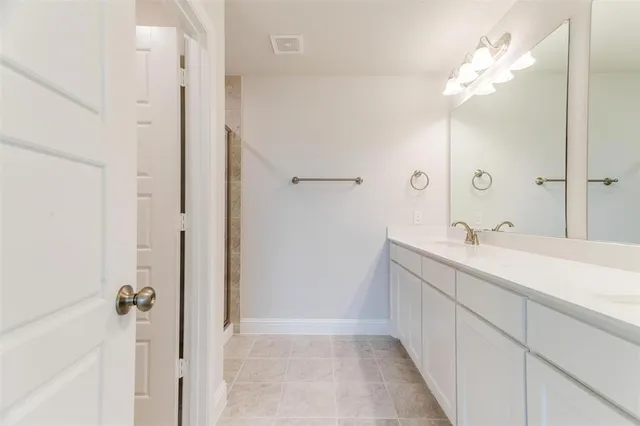 a bathroom with a double vanity sink mirror and vanity