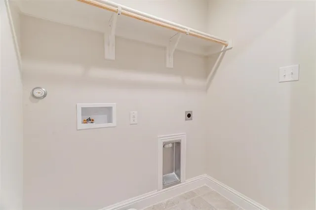 a view of a green field with wooden fence