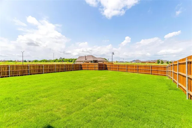a view of a house with a big yard and a large tree