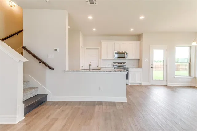 a view of kitchen with cabinets and wooden floor