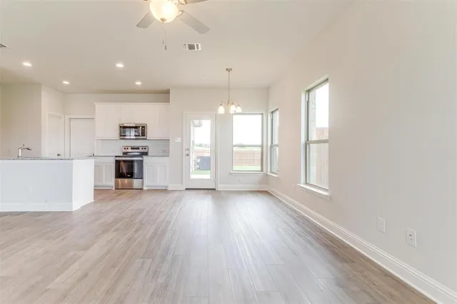 a view of a kitchen with a stove cabinets and wooden floor