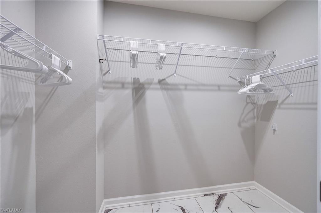 4607 Arboretum Circle, Unit 103 Naples, FL 34112 - Photo 14 of 29 a view of a room with racks on the wall