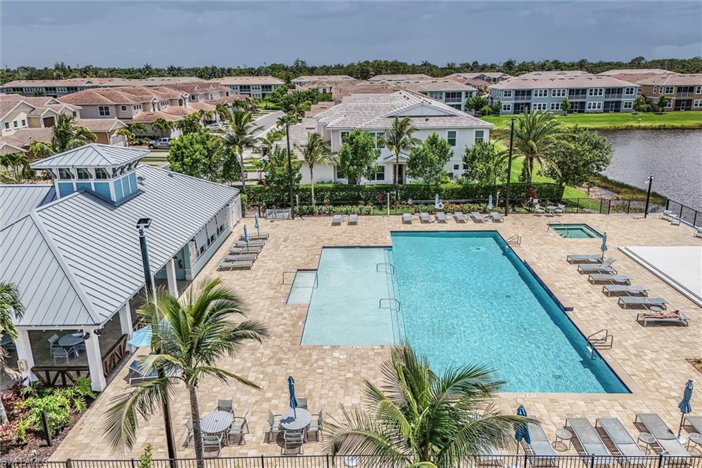 4607 Arboretum Circle, Unit 103 Naples, FL 34112 - Photo 25 of 29 a view of a swimming pool and a chairs