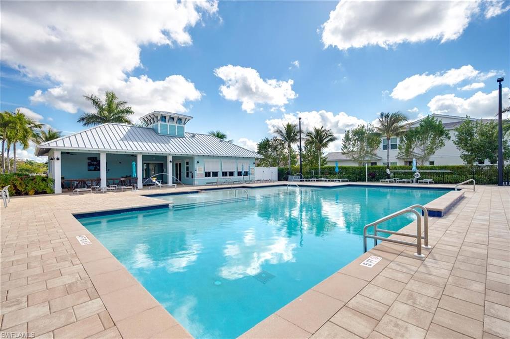 4607 Arboretum Circle, Unit 103 Naples, FL 34112 - Photo 28 of 29 a view of a house with swimming pool and a yard