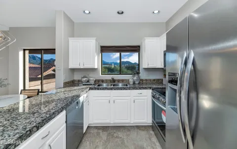 a kitchen with a sink stove and refrigerator