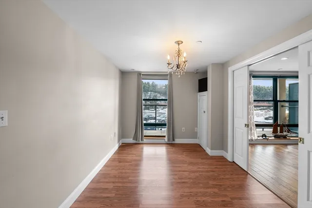a view of room with window and wooden floor